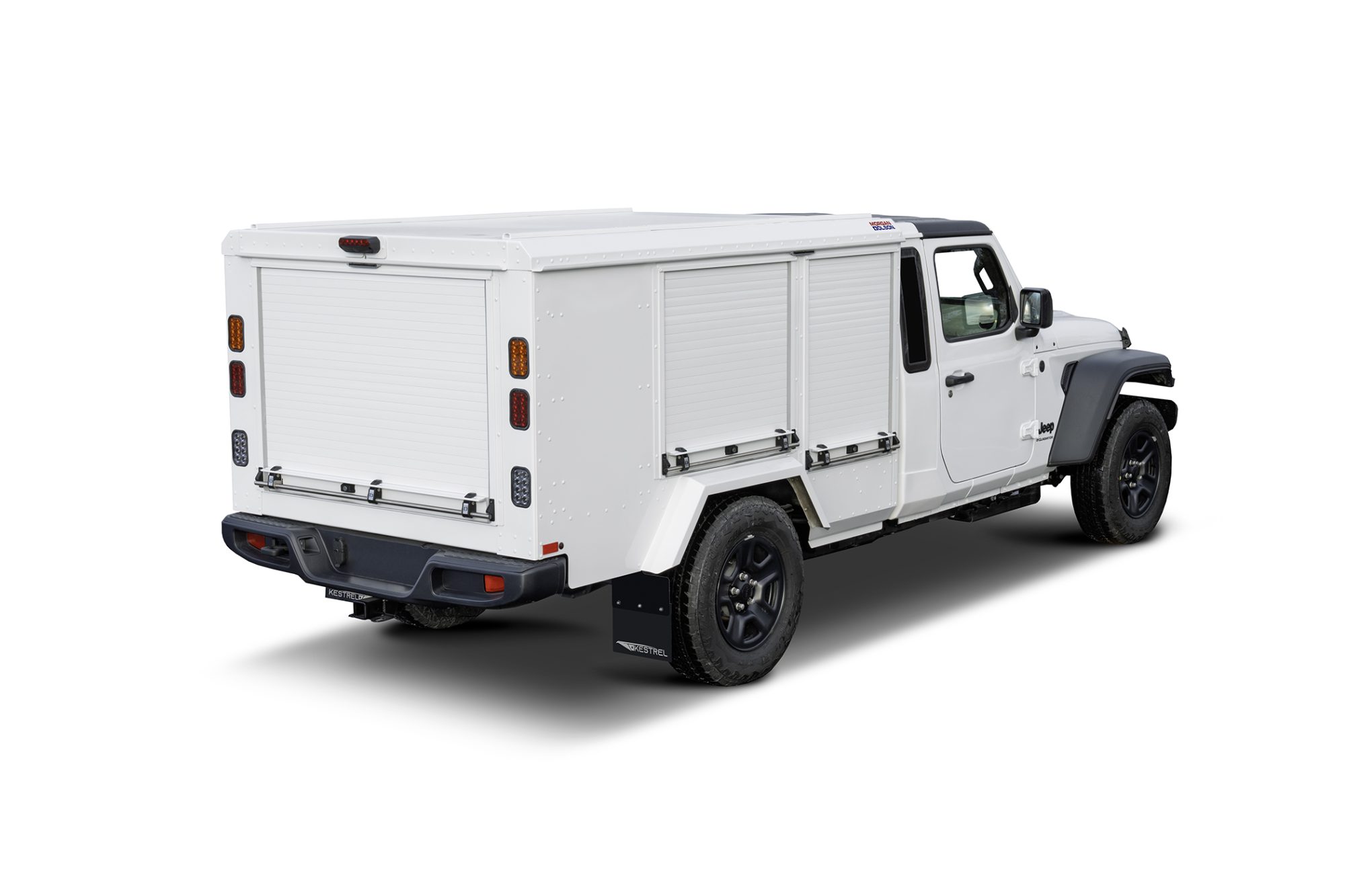 Rear-left view of a white service truck with multiple metal storage compartments and roll-up doors